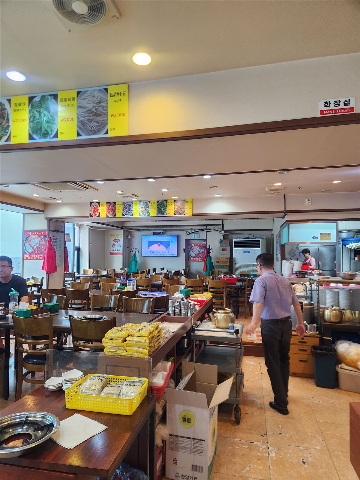Casual dining room with wooden tables at Songtan Budae Jjigae, Myeongdong Seoul