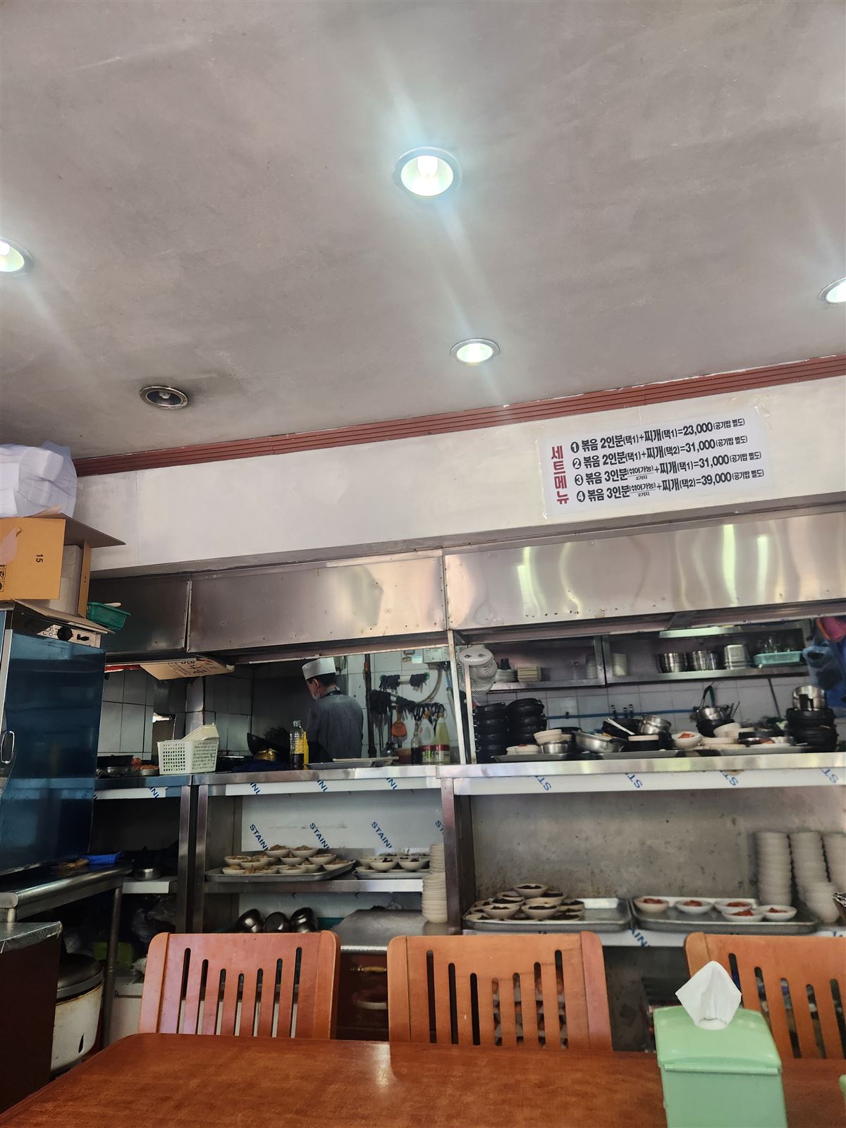 Plain, well-worn interior with stainless tables and an open kitchen at Sogongdong Ttukbaegijip, Seosomun Seoul