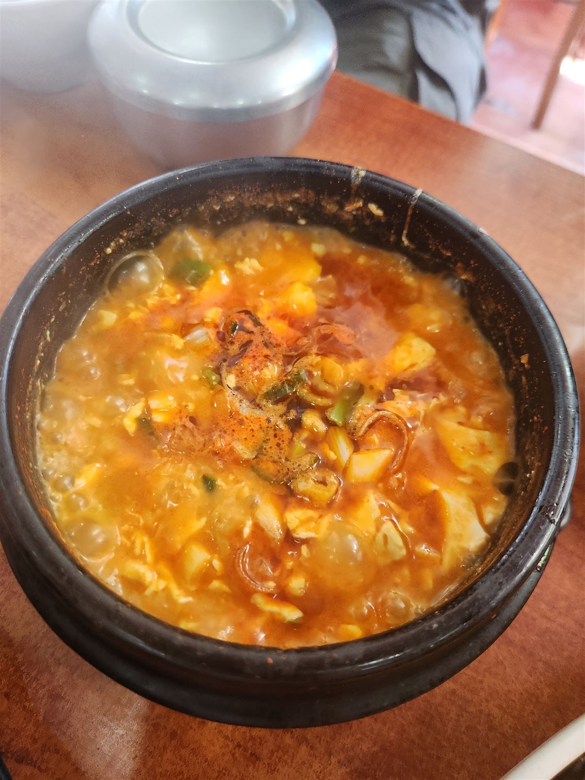Sundubu — soft tofu stew bubbling in a black earthenware pot at Sogongdong Ttukbaegijip, Seosomun Seoul