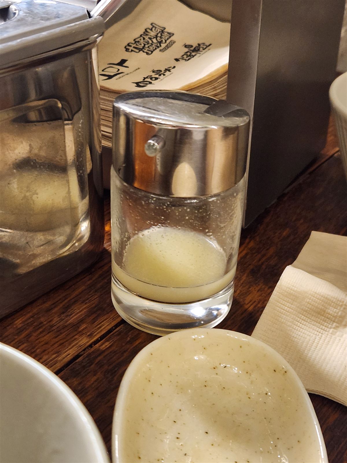 Jar of yuzu sauce and a dish of yuzu paste on the table at Yuzu Ramen, Seoul Station
