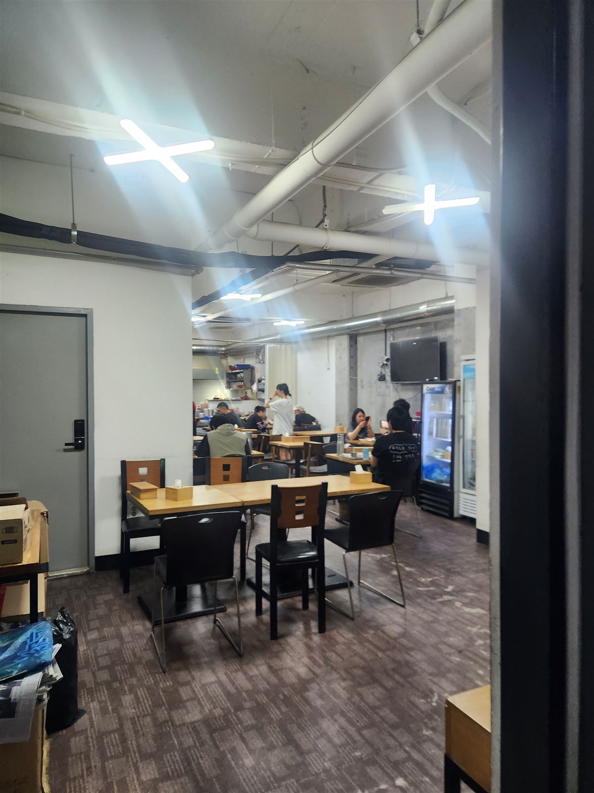 明洞未來食堂的地下室用餐區，外露管線與樸素桌椅